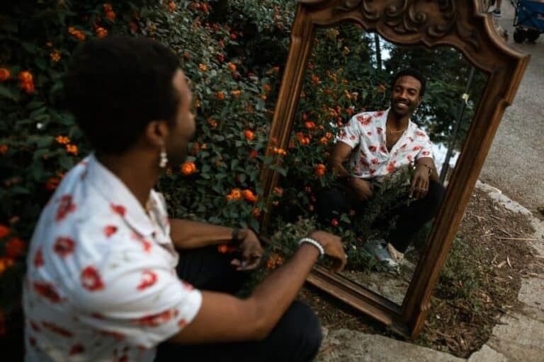 role of nutrition in addiction recovery, important facts, a man looking into a mirror next to a flower bush