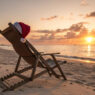 Healthy holiday season, Santa hat on a bench near beach